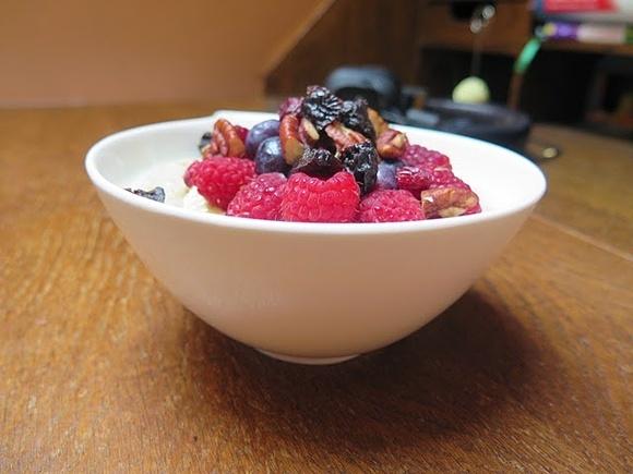 Owsianka na mleku z bananem, malinami, borówkami i orzechami pekan