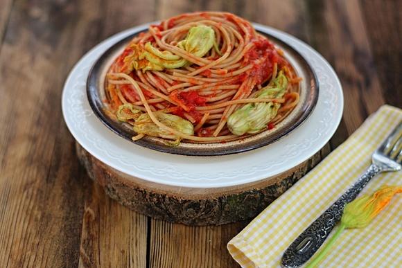 Pełnoziarniste spaghetti z pastą ajvar i kwiatami cukinii