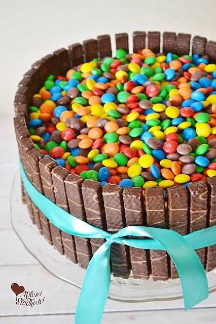Tort z cukierkami i kremem czekoladowo-truskawkowym otoczony wafelkami w czekoladzie